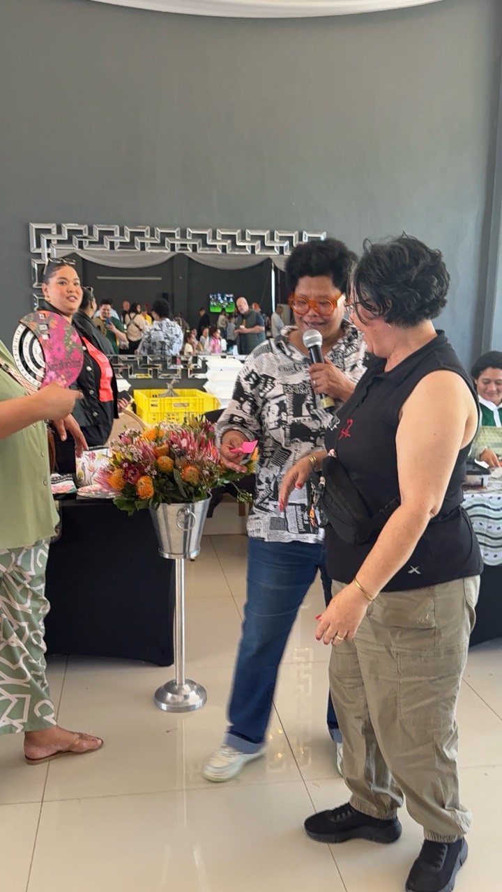 Market host engaging with a local vendor